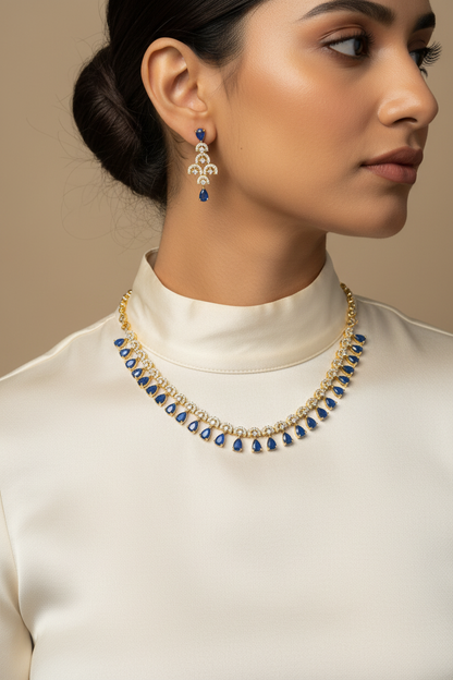 Close-up neck shot with blue sapphire necklace and earrings